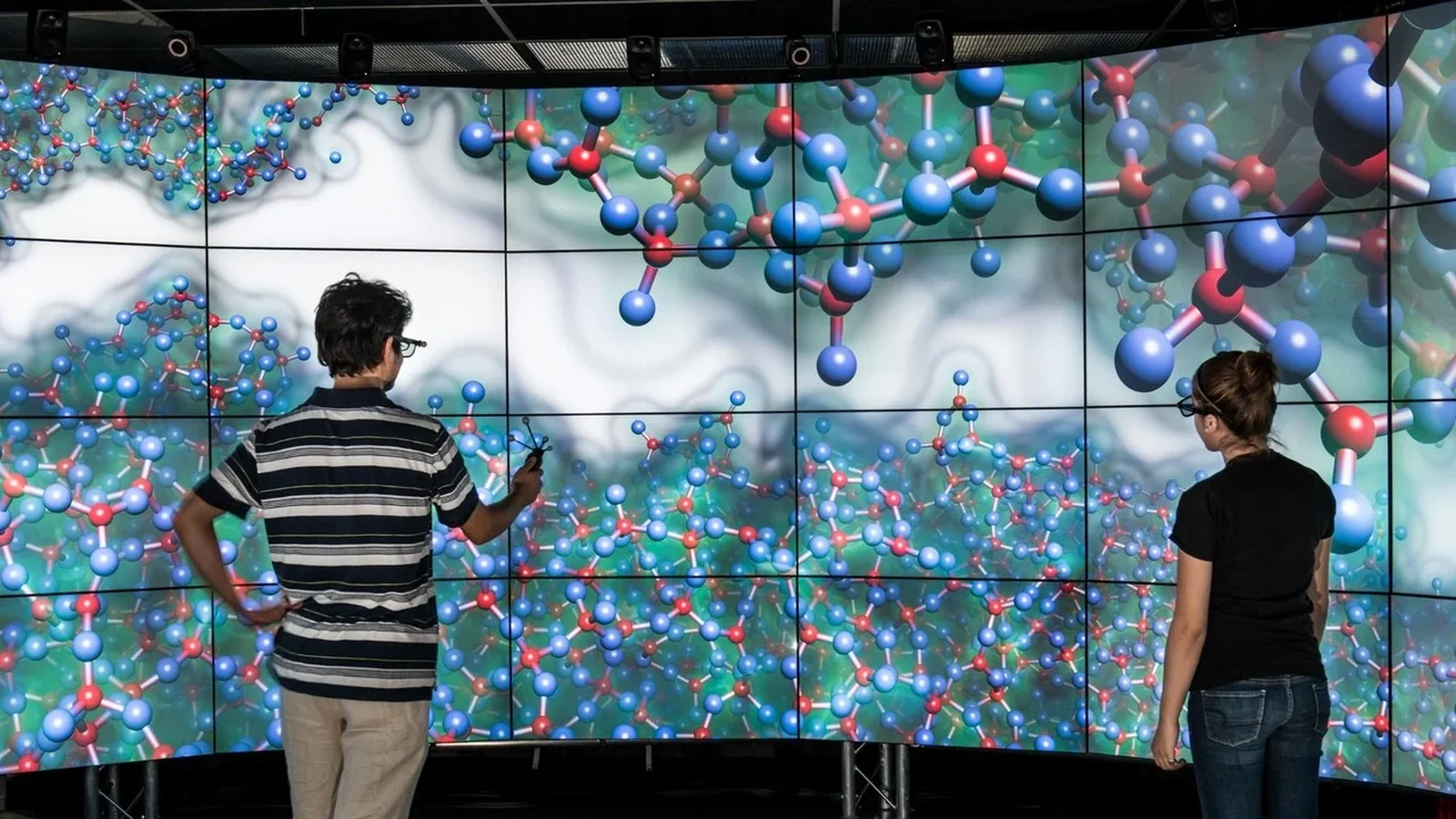 VR labs in universities: students exploring a shared 3D model together on an immersive wall display